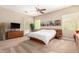 Bright primary bedroom with modern furniture, stylish accents, and a comfortable bed at 8647 W Lariat Ln, Peoria, AZ 85383