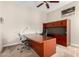 Office featuring a large wooden desk, office chair, built-in cabinetry, and natural lighting at 8647 W Lariat Ln, Peoria, AZ 85383