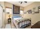 Comfortable bedroom featuring a black iron bed frame, stylish decor, and two bright windows at 9543 E Kiisa Dr, Scottsdale, AZ 85262