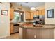 Well-lit kitchen showcasing wood cabinets, stainless steel appliances, and elegant granite countertops at 9543 E Kiisa Dr, Scottsdale, AZ 85262