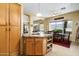 Open kitchen view with an island, wooden cabinets, and a breakfast nook next to a large window at 9543 E Kiisa Dr, Scottsdale, AZ 85262