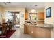 Spacious kitchen featuring granite countertops, wood cabinets and a view of the lushly landscaped backyard at 9543 E Kiisa Dr, Scottsdale, AZ 85262