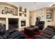 Cozy living room features a fireplace, tv and comfortable leather furnishings at 9543 E Kiisa Dr, Scottsdale, AZ 85262