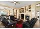 Open-concept living room with tile floors, a fireplace, and built-in display shelves at 9543 E Kiisa Dr, Scottsdale, AZ 85262