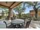 Charming patio with a stone table, surrounded by lush landscaping and a serene desert setting at 9543 E Kiisa Dr, Scottsdale, AZ 85262