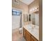 Well-lit bathroom with a single sink vanity, tile flooring and a shower/tub combo at 10401 N Saguaro Blvd # 123, Fountain Hills, AZ 85268