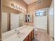Well-lit bathroom featuring a single sink vanity, large mirror and a shower/tub combo at 10401 N Saguaro Blvd # 123, Fountain Hills, AZ 85268
