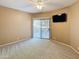 Neutral bedroom with a ceiling fan, patio access, and a wall-mounted television at 10401 N Saguaro Blvd # 123, Fountain Hills, AZ 85268