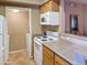 Kitchen area featuring wooden cabinets, tile floors and white appliances at 10401 N Saguaro Blvd # 123, Fountain Hills, AZ 85268