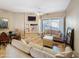 Inviting living room showcasing a cozy seating arrangement, ceiling fan, and a patio view at 10401 N Saguaro Blvd # 123, Fountain Hills, AZ 85268