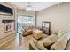 Well lit living room with tile floors, neutral colored furniture, and sliding glass door to patio at 10401 N Saguaro Blvd # 123, Fountain Hills, AZ 85268