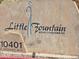 Little Fountain Resort Condominiums signage with street address and a beige textured background at 10401 N Saguaro Blvd # 123, Fountain Hills, AZ 85268