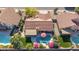 Aerial view of a home with a backyard featuring a private pool, covered patio, and colorful umbrellas for outdoor enjoyment at 13533 N 91St Way, Scottsdale, AZ 85260