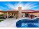 Backyard view featuring a sparkling pool, covered patio, and well-maintained landscaping at 13533 N 91St Way, Scottsdale, AZ 85260