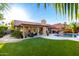 Backyard oasis featuring a pool, patio with furniture, artificial grass and lush landscaping at 13533 N 91St Way, Scottsdale, AZ 85260