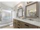 Bathroom with double sink vanity, granite counters, and glass enclosed walk-in shower at 13533 N 91St Way, Scottsdale, AZ 85260