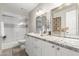 Bathroom featuring granite counters, double sink vanity, and shower-tub combo at 13533 N 91St Way, Scottsdale, AZ 85260