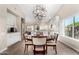 Bright dining area with modern lighting, hardwood floors, and access to the updated kitchen at 13533 N 91St Way, Scottsdale, AZ 85260