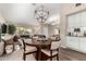 Elegant dining area with a chandelier, modern decor, and a view of the living space at 13533 N 91St Way, Scottsdale, AZ 85260