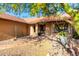 Attractive home entrance with a tiled walkway and desert landscaping under the shade of a tree at 13533 N 91St Way, Scottsdale, AZ 85260