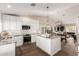 Modern kitchen with white cabinetry, granite countertops, stainless steel appliances and wood flooring at 13533 N 91St Way, Scottsdale, AZ 85260