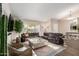 Well-lit living room with a large sectional sofa, decorative rug, and an inviting open layout at 13533 N 91St Way, Scottsdale, AZ 85260