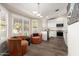Cozy living area with hardwood floors, plantation shutters, and views into the kitchen at 13533 N 91St Way, Scottsdale, AZ 85260