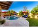 Inviting pool area with lounge chairs, lush landscaping, and beautiful desert views at 13533 N 91St Way, Scottsdale, AZ 85260