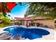 Inviting backyard pool with comfortable seating, lush landscaping, and mature palm trees at 13533 N 91St Way, Scottsdale, AZ 85260