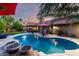 Stunning backyard featuring a refreshing pool, fountains, and an outdoor kitchen area at 13533 N 91St Way, Scottsdale, AZ 85260