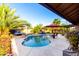 Stunning pool with cascading fountains, poolside seating, and tropical landscaping at 13533 N 91St Way, Scottsdale, AZ 85260