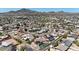 Expansive aerial view capturing a residential neighborhood against a mountain backdrop at 1511 E Carol Ave, Phoenix, AZ 85020