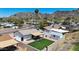 Aerial view showcasing a well-kept backyard with a covered patio and desert landscaping at 1511 E Carol Ave, Phoenix, AZ 85020