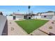 Large backyard showcasing a well-maintained lawn, covered patio, and ample space at 1511 E Carol Ave, Phoenix, AZ 85020