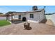 Backyard with a covered patio, sliding glass doors, and a cozy fire pit at 1511 E Carol Ave, Phoenix, AZ 85020