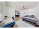 Bright bedroom featuring a modern ceiling fan, wood floors, and view to the common area at 1511 E Carol Ave, Phoenix, AZ 85020