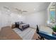 Bright and airy bedroom featuring ample natural light, a comfortable bed, and a functional workspace at 1511 E Carol Ave, Phoenix, AZ 85020