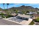 Charming single-story home featuring a rock driveway and a bright white fence, nestled in a peaceful neighborhood with a mountain backdrop at 1511 E Carol Ave, Phoenix, AZ 85020