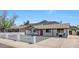 Beautifully maintained single-story home showcasing a bright red front door, rock driveway, and a charming curb appeal at 1511 E Carol Ave, Phoenix, AZ 85020