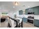 Inviting eat-in kitchen featuring stainless steel appliances and modern cabinetry, seamlessly blending with the living area at 1511 E Carol Ave, Phoenix, AZ 85020