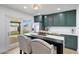 Well-lit kitchen with an eat-in table and stainless steel appliances, offering a seamless transition to the outdoor space at 1511 E Carol Ave, Phoenix, AZ 85020