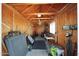 Interior of a wooden storage shed with ample storage, shelving, and natural light at 1511 E Carol Ave, Phoenix, AZ 85020