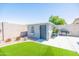 Fully fenced backyard featuring artificial turf, a shed and a grill, perfect for outdoor entertainment at 1550 W Saint Kateri Dr, Phoenix, AZ 85041
