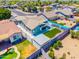 Aerial view of a cozy backyard featuring artificial turf, covered patio, and privacy fence for outdoor entertaining at 1550 W Saint Kateri Dr, Phoenix, AZ 85041