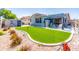 Beautiful backyard featuring artificial turf and a covered patio for outdoor dining and relaxation at 1550 W Saint Kateri Dr, Phoenix, AZ 85041