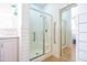 Bright bathroom featuring a walk-in shower with glass doors and white subway tile at 1550 W Saint Kateri Dr, Phoenix, AZ 85041