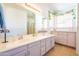 Well-lit bathroom with double sinks, large mirrors, and vanity space for daily routines and personal care at 1550 W Saint Kateri Dr, Phoenix, AZ 85041