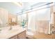 Bright bathroom featuring a bath tub with sliding glass doors and neutral tile at 1550 W Saint Kateri Dr, Phoenix, AZ 85041