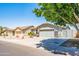 Single-story home featuring desert landscaping, neutral stucco exterior, and attached three-car garage at 1550 W Saint Kateri Dr, Phoenix, AZ 85041