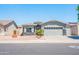 A well-kept single Gathering home with stone accents, desert landscaping, and a three-car garage at 1550 W Saint Kateri Dr, Phoenix, AZ 85041
